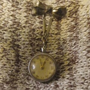 Vintage Bow Clock With Glass Dial Covering.